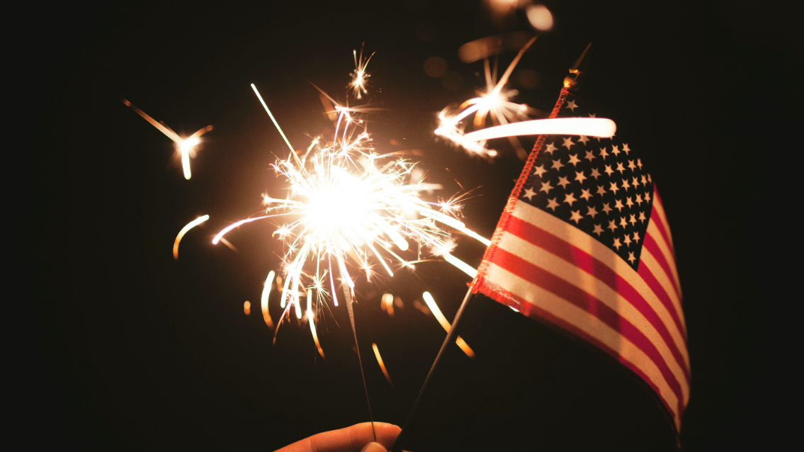 Celebrate the Fourth of July with sparklers and flags.