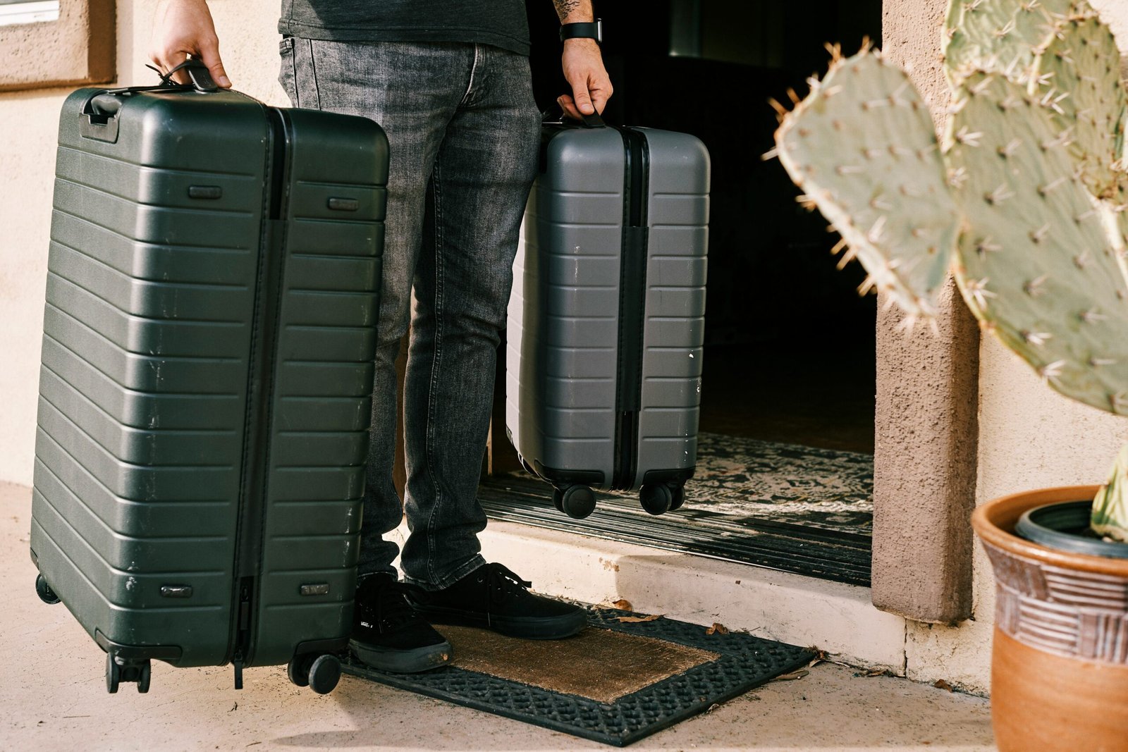 man carrying two suitcases