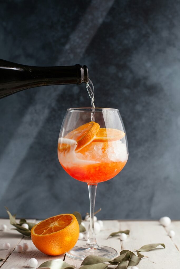 Peachy Sunset Sangria Summer Cocktail in a wine glass